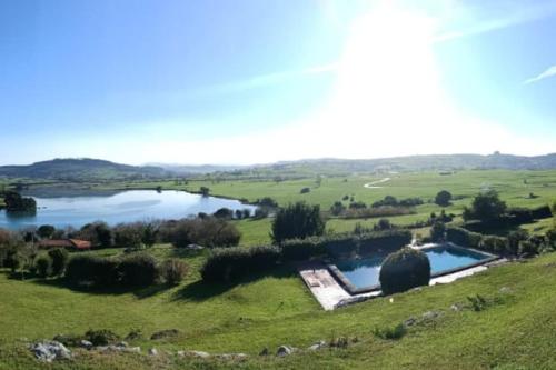 an aerial view of a lake in a field at Casa con piscina en Ajo - Las Arrañadas in Bareyo