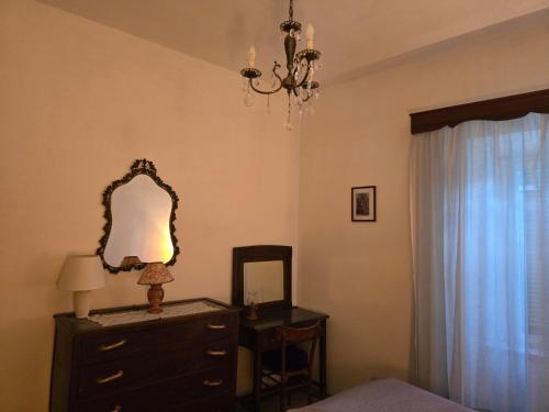 a bedroom with a dresser and a mirror and a lamp at Alloggio turistico - Sole dall'alba al tramonto in Sezze