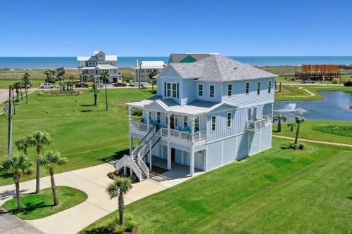 an aerial view of a large white house at Rise and Shine Beach House with Ocean Views and Pointe West Resort Pools in Galveston
