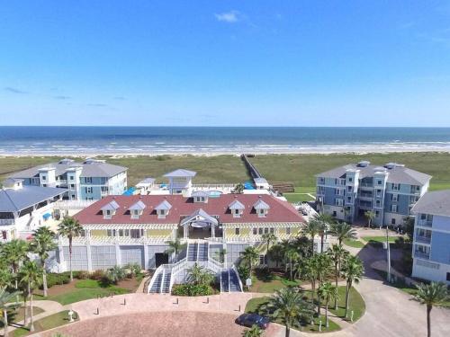 an aerial view of a resort with the ocean at Rise and Shine Beach House with Ocean Views and Pointe West Resort Pools in Galveston