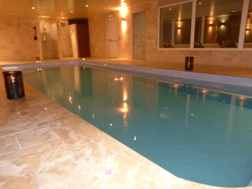 a large swimming pool in a hotel room at Dunamoy Cottages & Spa in Ballyclare