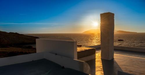 a sunset over the ocean from a villa at Onar Suites & Villas in Karavostasi