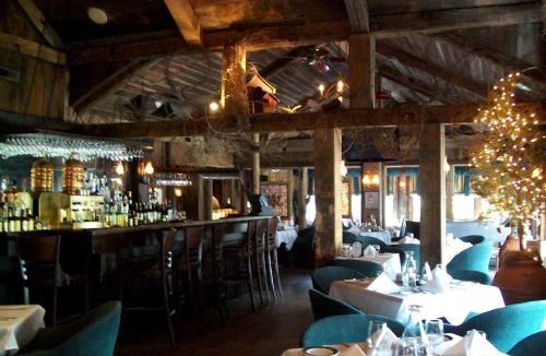 um restaurante com mesas e cadeiras e um bar em Mario's International Spa, Hotel & Restaurant em Aurora