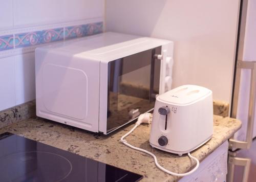 a microwave sitting on top of a kitchen counter at Apartacentro in Soria