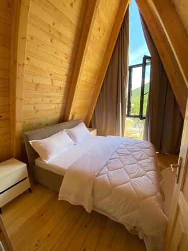 a bedroom with a bed in a wooden room at Monark Villas in Shkodër