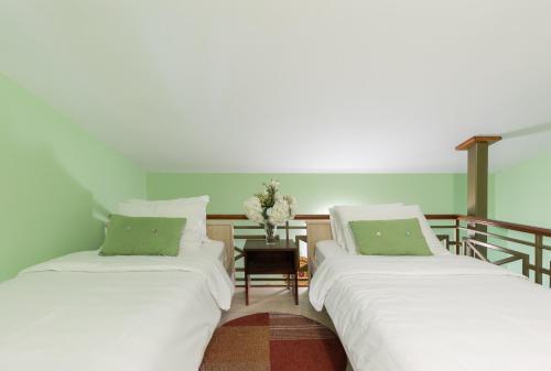 two beds sitting next to each other in a room at Vučković Studios in Kotor