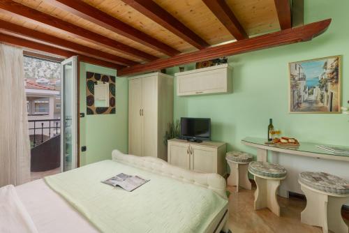 a living room with a couch and a table and a counter at Vučković Studios in Kotor
