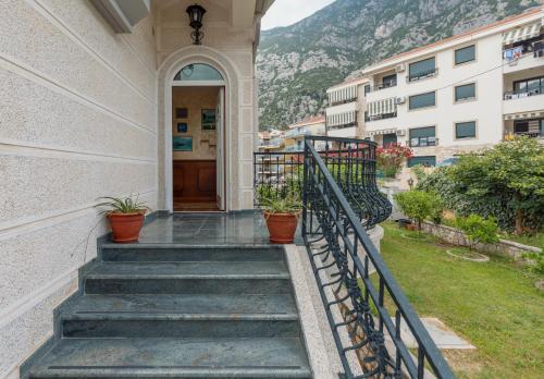 a staircase leading to a building with potted plants at Vučković Studios in Kotor