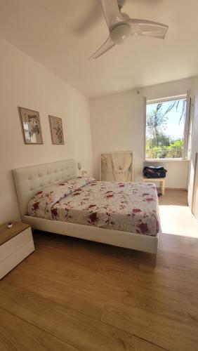 a bedroom with a bed and a ceiling fan at Elba in relax in Rio Marina