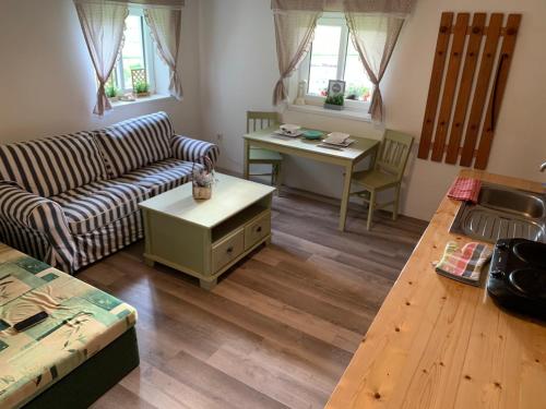 a living room with a couch and a table at Penzion Felden in Jablonné v Podještědí