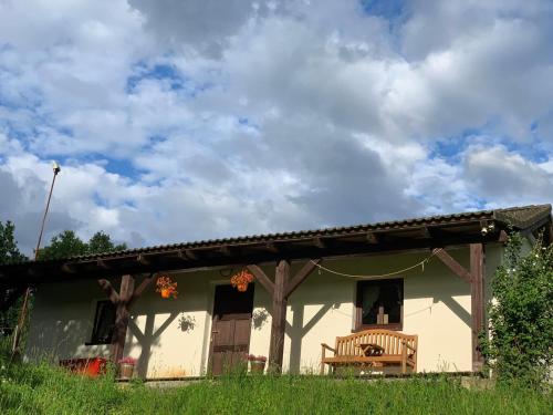 a house with a bench in front of it at Penzion Felden in Jablonné v Podještědí