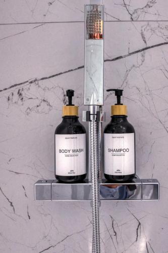 two bottles of soap on a shelf in a bathroom at Short Time Suites Toulon Centre 3 "LE SPOT" Check-in auto in Toulon
