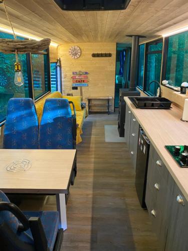 une cuisine et une salle à manger d'un bus dans l'établissement Woody Wood Bus, à Vergeroux