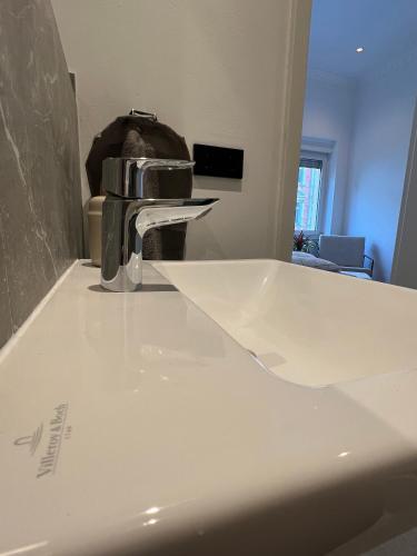 a faucet sitting on top of a white sink at Modern Stay I Cosy & Central Apartments in Koblenz