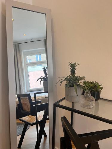 a dining room with a table and a mirror at Modern Stay I Cosy & Central Apartments in Koblenz