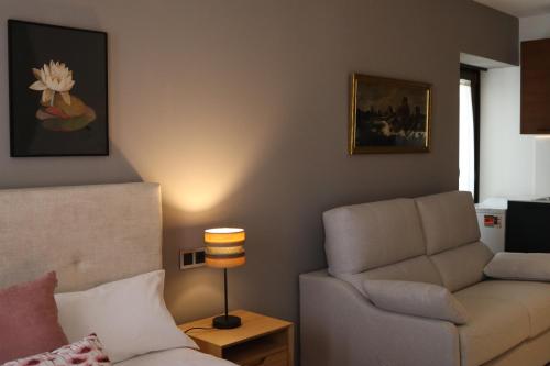 a living room with a couch and a chair at La Quinta del Sordo in Luarca