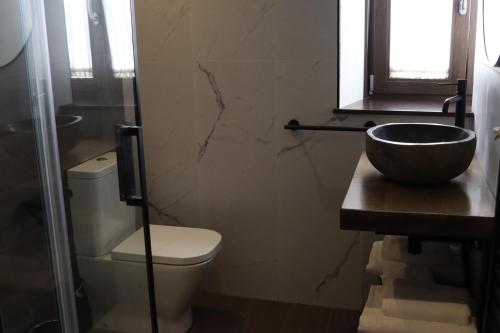 a bathroom with a toilet and a sink at La Quinta del Sordo in Luarca