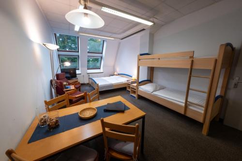a room with a dining table and a bunk bed at IT Centrum Apartments in Vrchlabí