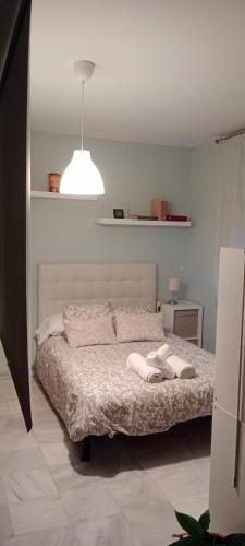 a bedroom with a bed with two towels on it at Casa curro in Baena