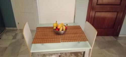 a bowl of fruit sitting on top of a table at Casa curro in Baena