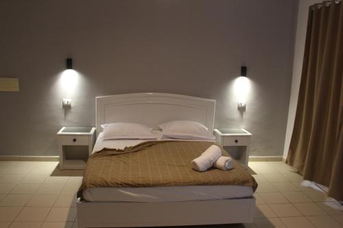a bedroom with a large bed with two night stands at Hôtel Medina in Sousse