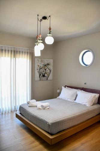 a bedroom with a large bed with two towels on it at Terra Nova Luxury Villa in Mystras