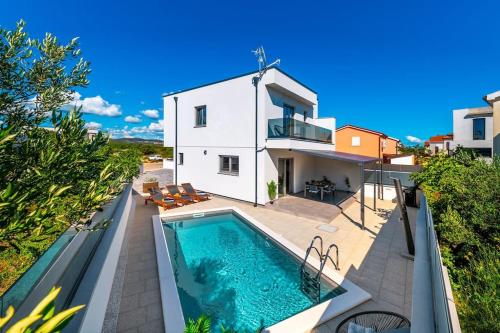 an image of a house with a swimming pool at Holiday home Val in Šibenik