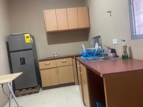 a kitchen with a refrigerator and a sink at 2 Bedroom House in Accra in Accra