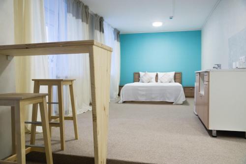 a large room with a bed and a table at Flats Kruzhka-podushka on Krisanova Street in Perm