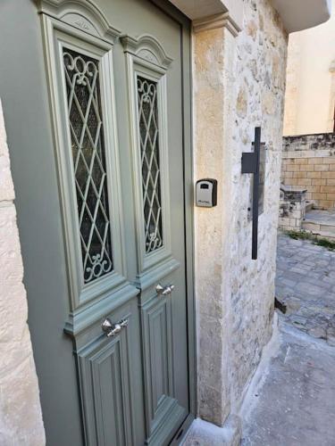 a door to a building with a stone wall at Rafeio Roustic Maisonette in Episkopi (Heraklion)