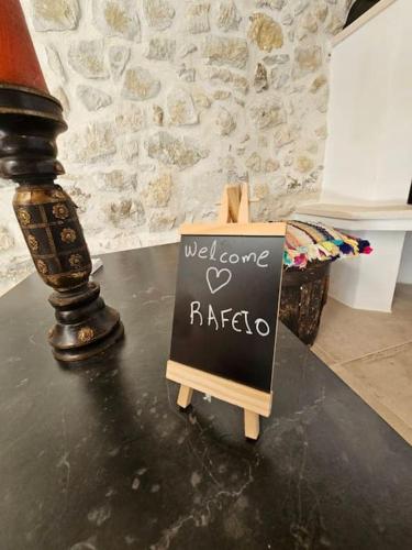 a sign that says welcome raibo on a table at Rafeio Roustic Maisonette in Episkopi (Heraklion)