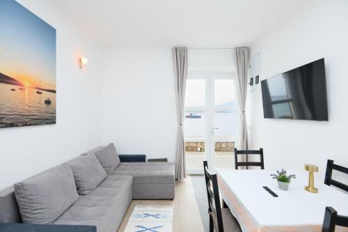 a living room with a couch and a table at Beloc House Lopud Island in Lopud Island