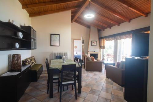 a dining room and living room with a table and chairs at Luxury Beach Villa in Skála