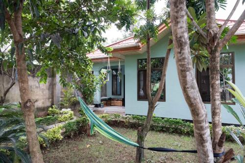 a house with a green hose in front of it at Tukutane Kilimanjaro - Homestay in Uru