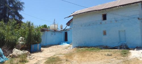 a white building with a metal roof at KETAMA ketama in Ketama