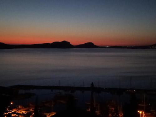 a sunset over a body of water with mountains at Bay blue in Pylos