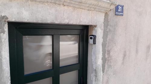 a door in a building with a cell phone on it at Blue Charm Suite in Dubrovnik