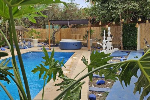 a swimming pool in a backyard with a fence at La kasbah bleue in Marrakech