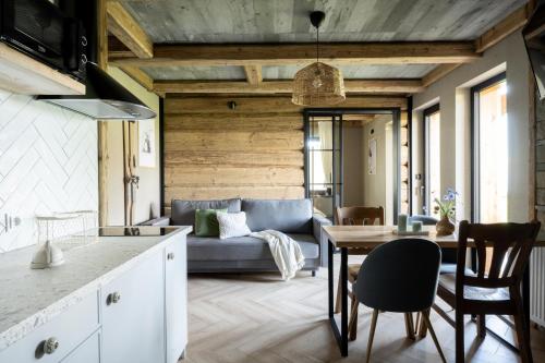 a kitchen and living room with a table and a couch at apartamenty 1006 m n p m in Bustryk