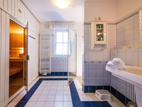 a blue and white bathroom with a tub and a sink at Blue Wonder Comfortable holiday residence in Zinnowitz
