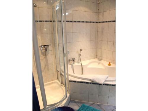 a bathroom with a shower and a bath tub at Winkelchen Comfortable holiday residence in Cochem