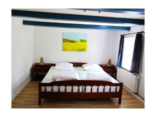 a bedroom with a bed with a blue ceiling at Midgard Comfortable holiday residence in Nieby