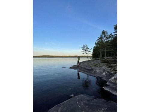 a person standing on the shore of a lake at Pure relaxation in Sweden in Molkom