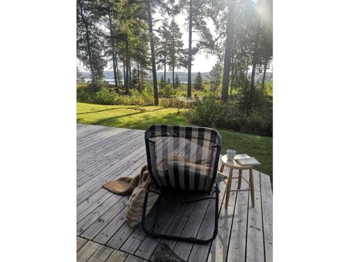 a black chair sitting on a deck with a table at Pure relaxation in Sweden in Molkom