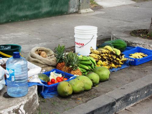 a bunch of fruits and vegetables in baskets on a curb at B&B, family run homestay, Hospedaje La Penita in Altagracia