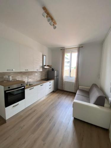 a living room with a couch and a kitchen at Levante Apartment in Bologna