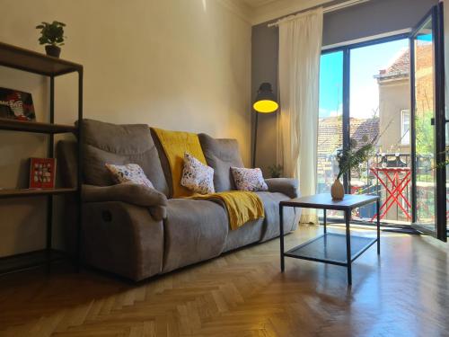 a living room with a couch and a table at Perfect Long-term Stay Stylish and Spacious Top Center Next to Vitosha Blvd in Sofia