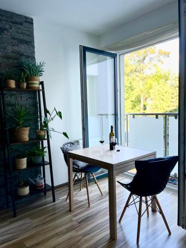 a dining room with a table and two chairs at Apartament Olszowka 12 Bielsko - Biała in Bielsko-Biała