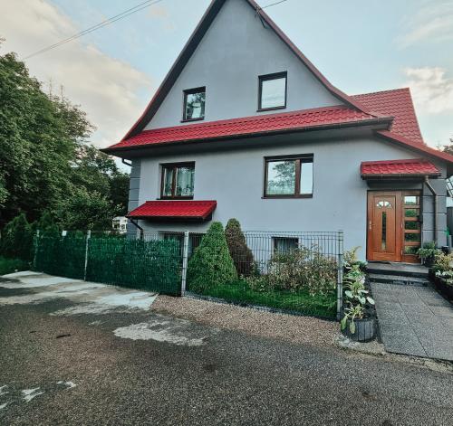 a white house with a red roof at Smile Apart in Biały Dunajec