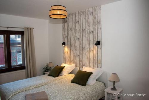 a bedroom with a bed with two pillows at Cielle sous Roche in La-Roche-en-Ardenne
